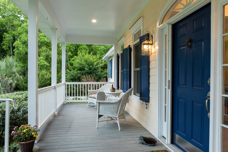 Covered Porch with chairs and Blue door